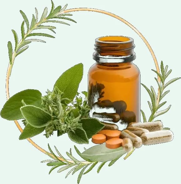 Herbs arranged around a glass bottle of capsules and tablets